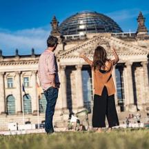 a man and a woman standing in front of a building