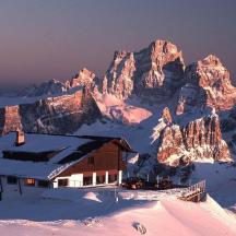 a house on top of a mountain in the snow
