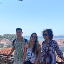 a group of three people standing on top of a building