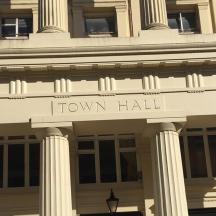 a front of a building with the words town hall
