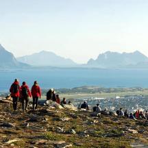 a group of people walking up a hill