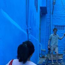 a young boy standing in a blue alley