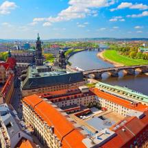 an aerial view of a city with a river and buildings