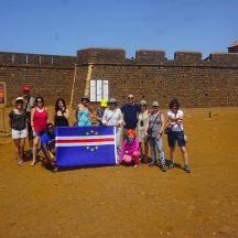 a group of people posing for a picture with a flag