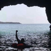 a person in the water in a cave