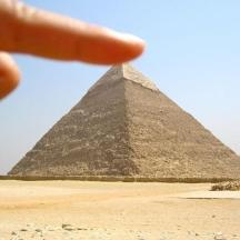 a hand pointing at the pyramids