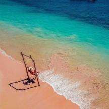 a dead boat on a beach near the water