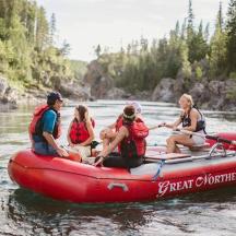 a group of people in a raft on a river
