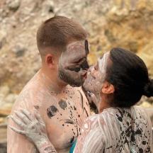 a man and a woman covered in mud