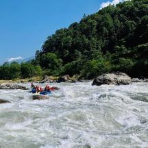 a group of people in a raft in a river