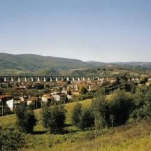 a view of a town with a bridge in the background