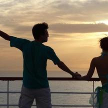 a man and a woman standing in front of the ocean