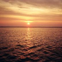 a sunset over a large body of water