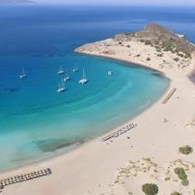 an aerial view of a beach with boats in the water
