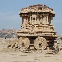 a large stone building with an elephant standing next to it