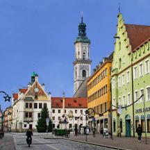 a city street with buildings and a clock tower