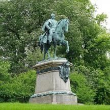 uma estátua de um homem a cavalo em um campo