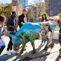 a group of people standing in front of a statue