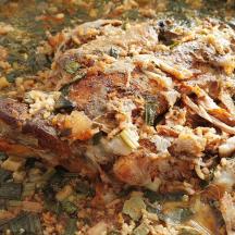 a casserole dish of food with meat and vegetables