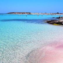 a beach with people swimming in the water