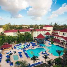 an aerial view of a resort with a pool and a beach
