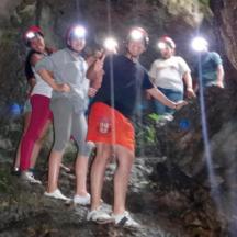 a group of people standing in a cave