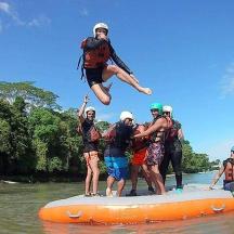 a group of people on an orange raft in the water