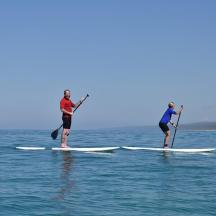 two people on paddle boards in the water