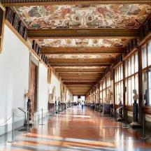 a hallway in a museum with statues on the walls