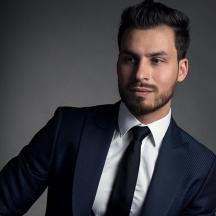 a man in a suit and tie posing for a picture
