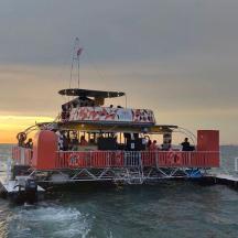 a ferry boat in the water at sunset