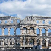 a large stone building with arches in front of it