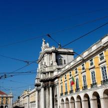 a yellow building with a statue on top of it