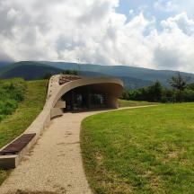 a bench on a grassy field next to a building