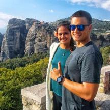 a man and a woman standing on top of a mountain
