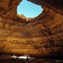 a group of people standing in a cave