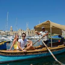 a group of people sitting on a boat in the water