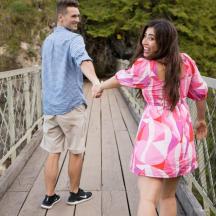 a man and a woman standing on a bridge