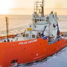 a large orange boat in the water