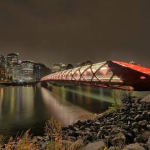 a bridge over a river in a city at night