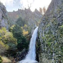 a waterfall on the side of a rocky mountain
