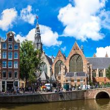 a city with a bridge over a river and buildings