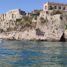 a boat in the water in front of a castle