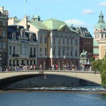 a bridge over a river in a city with buildings