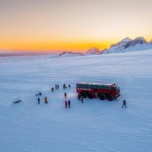 a group of people standing around a fire truck in the snow
