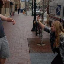 a man and a woman standing on a sidewalk