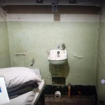 a bathroom with a sink and a bed in it