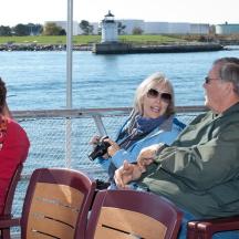 a group of people sitting on a boat in the water