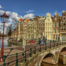 a bridge over a river in a city with buildings
