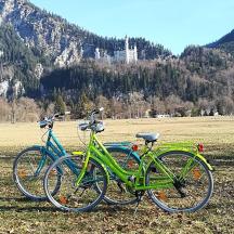 two bikes parked next to each other in a field